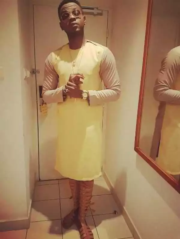 Kiss Daniel Shows Off Unusual Outfit & Gladiator Sandals